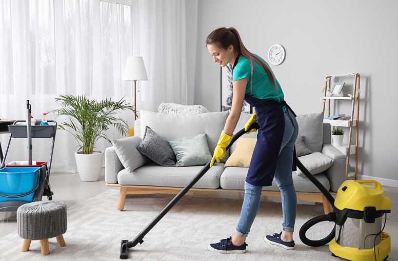 Commercial cleaner in Washington DC, Virginia, and Maryland vacuuming a white carpet in a living room